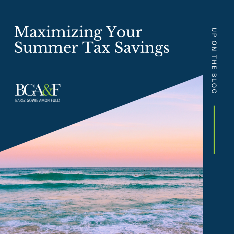 Scenic beach view with clear blue water, white sand, and a bright summer sky, symbolizing the relaxing possibilities of maximizing summer tax savings.